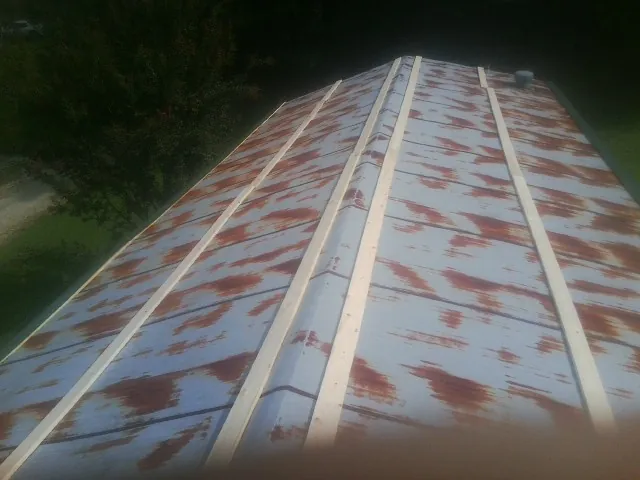 Rusted metal roof panels with new wood purlins before replacement — Storm Damage Roof Repair in Charleston by Roofing Brothers